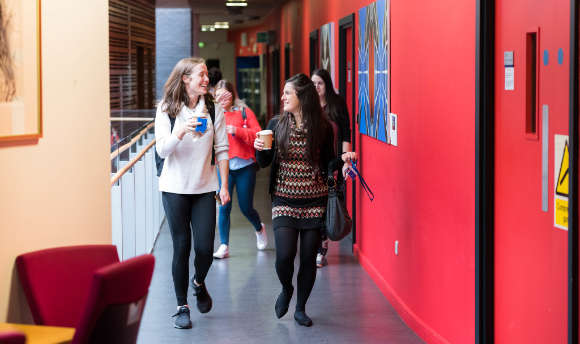 A couple of students walking down the corridor at  Edinburgh